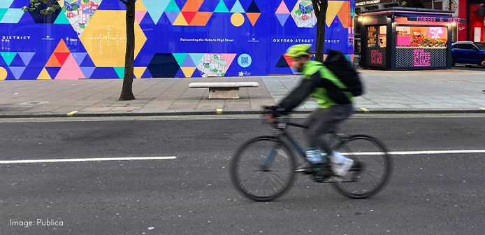 A person riding a bicycle on Oxford Street